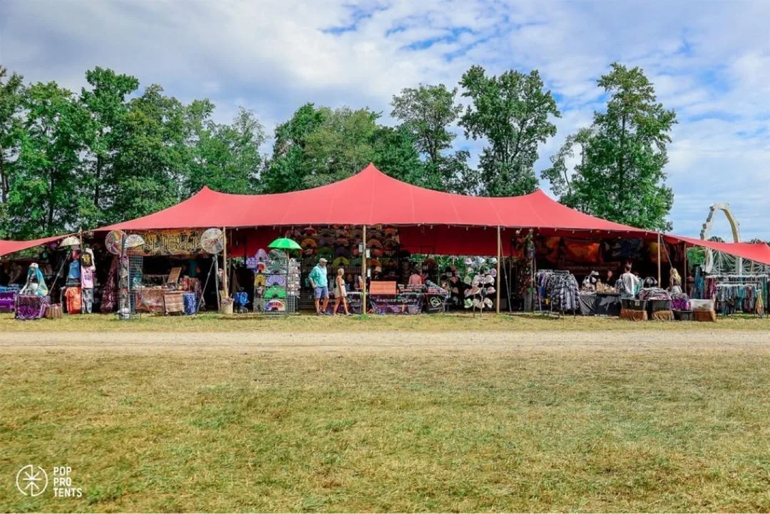 Festival guests enjoying shaded haven spa area under stretch tent